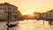 Venice at sunset, Italy. Gondola with tourists sails on Grand Canal at night