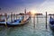 Venice. A sunset over the channel Grande and gondolas at the mooring