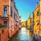 Venice sunset in Rio de la Pleta water canal and Sant Antonin church campanile. Italy