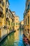 Venice sunset in water canal and traditional buildings. Italy