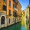 Venice sunset in water canal and traditional buildings. Italy