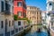 Venice traditional view with historic buildings and small boat the channel street.