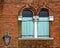 Venice, two pointed arch windows on a brick wall