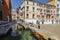 Venice. Urban landscape with canal, bridge, gondola, tourists