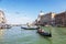 Venice, view of the Grand Canal with floating gondolas with tourists and the Cathedral of Santa Maria della Salute