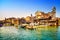 Venice, water canal, bridge and gondolas or gondole depot. Italy