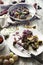 Venison dish on old wooden table, with fruits jam, cheese and chestnuts