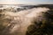 Venta Rapid waterfall, the widest waterfall in Europe and long red brick bridge in foggy, sunny autumn morning, Kuldiga, Latvia.