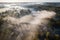 Venta Rapid waterfall, the widest waterfall in Europe and long red brick bridge in foggy, sunny autumn morning, Kuldiga, Latvia.