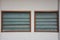 Ventilated louvered windows with wooden frames and opaque glass shutters