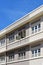 Ventilation air vents and louvered windows along exterior of refurbished pre-war building in streamlined modern art deco style