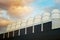 Ventilation pipes on the roof of an industrial building on colorful sky background