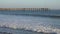 Ventura, California Pier View and Surfers Paddling Out During the Late Afternoon