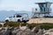 Ventura, California, USA -  June 19, 2020: A Harbor Patrol vehicle at Ventura Harbor patrols the beach and shore near a lifeguard