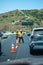 Ventura County Fire Department personnel and Caltrans workers direct traffic near a downed motorcyclist