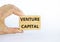 Venture capital symbol. Wooden blocks with words Venture capital on beautiful white background, copy space. Businessman hand.