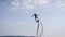 Venturous sportive person doing tricks at jet pack over water