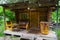 The veranda of a small wooden bathhouse on the porch of which there are benches and a large old bath. Rest and health in nature