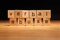 Verbal abuse words written on wood cube