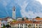 Verbania is a small town in Northern Italy. Old stone houses and a Church bell tower against the background of the Alpine