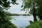 Verdant lake shore in cloudy summer