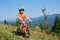 Verkhovyna, Ukraine - August 19, 2017: boy in helmet, shorts and T-shirt cycling three-wheeled child bike down the hill