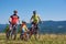 Verkhovyna, Ukraine - August 19, 2017: tourist family, smiling mom, dad and boy with modern bicycles on top of mountain