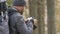 Verkhovyna, Ukraine - December 11, 2020: Photographer with hiking backpack taking pictures of nature with digital photo