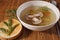 Vermicelli soup and field mushrooms in a plate on a straw napkin