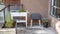 A vermicomposting system worm composter sits on an apartment balcony with other patio planters.