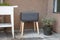 A vermicomposting system worm composter sits on an apartment balcony with other patio planters.