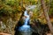 Vermont waterfall in tight gorge at eye level during fall