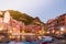 Vernazza town at night, long exposure of the romantic village in CInque terre park at dusk with moving boats