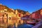 Vernazza village, church, boats and sea harbor on sunset. Cinque Terre, Ligury, Italy