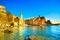 Vernazza village, church, rocks and sea harbor on sunset. Cinque Terre, Ligury, Italy