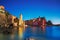 Vernazza village, church, rocks and sea harbor on sunset. Cinque Terre, Ligury, Italy