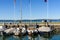 Verona, italy - october 2, 2021: A wedding couple sitting with their backs on the harbor wall look at the lake on a weekend