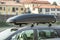 Verona, Italy - October 21, 2019: A car with roof baggage trunk parked on the side of the street on a parking lot