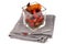 Verrine of candied peppers placed on a napkin with a fork close-up on a white background
