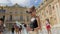 Versailles, Paris, France - August 2018: Beautiful caucasian female tourist with smartphone in her hand and smart for