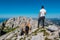 Vertatscha - Hiker man with scenic view of majestic mountain peak Hochstuhl (Stol) in untamed Karawanks