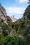 Vertical of the Abbey of Montserrat rocky mountains and trees clear sky background
