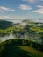 Vertical aerial shot of vast green meadows