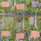 Vertical aerial view of an allotment garden with huts, paths and vegetable beds