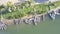 Vertical aerial view fishing boats moor at calm river bank