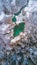 Vertical aerial view of frozen trees and a lagoon in Reservat Zelenci,Triglav national park,Slovenia