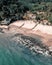 Vertical aerial view of low sea tides washing up on the shore of a tropical island in Thailand