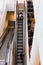 Vertical aerial view of young boy and girl in retail clothes store escalator