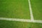 Vertical angle view of the white line on a grass soccer field