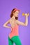 Vertical back view of sporty ginger girl with curves, makes workout with dumbbells